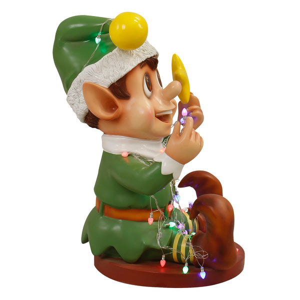 Naughty Christmas Elf Playing With Multicoloured Lights in Green Outfit Display Prop