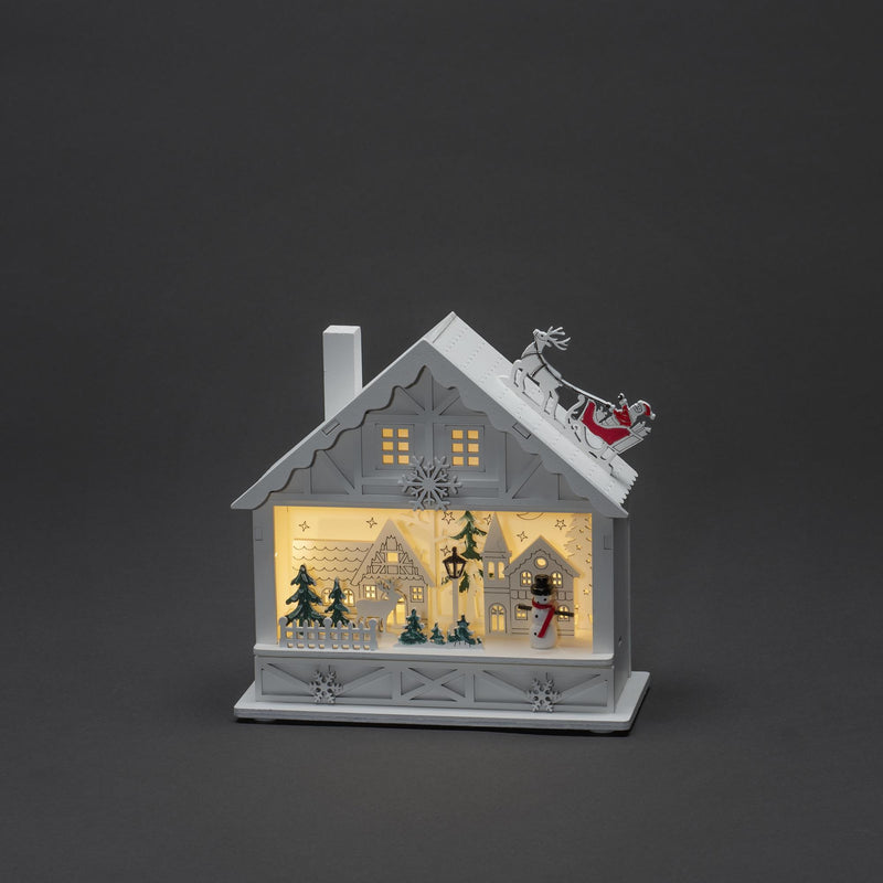 Christmas White Wooden House with Santa On The Roof Scene