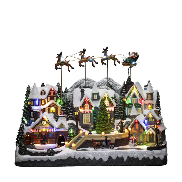 Magical Christmas Village Scene with Flying Santa and Reindeer