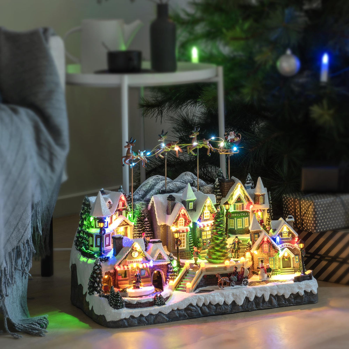 Magical Christmas Village Scene with Flying Santa and Reindeer