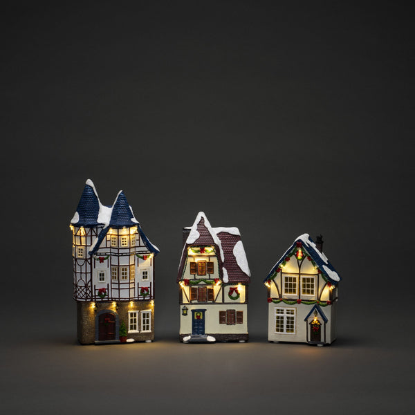 Trio of Small Houses Lit with LED Lights