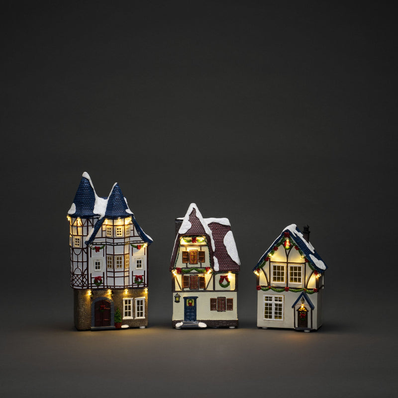 Trio of Small Houses Lit with LED Lights