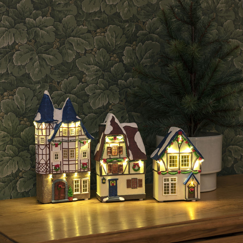 Trio of Small Houses Lit with LED Lights